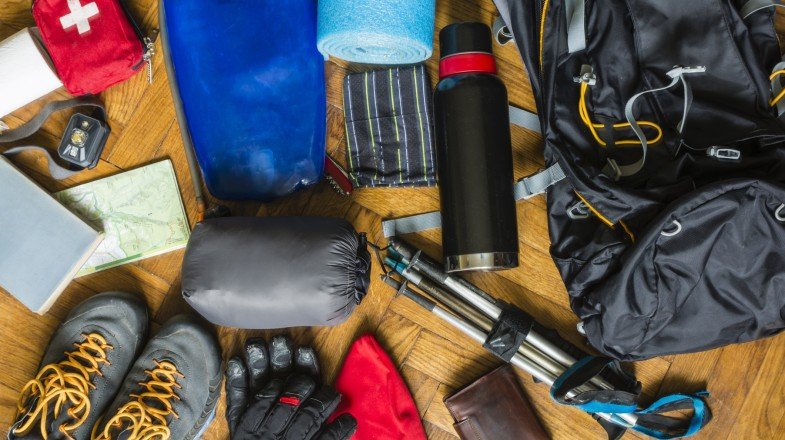 Trekking gear and equipment organized for packing